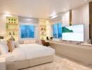 Well-lit bedroom with modern decor, large windows, built-in shelves, and a flat screen TV