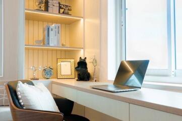 Modern home office with shelving, decor, and a large window