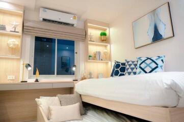 Modern bedroom with integrated storage, air conditioning, and a large bed