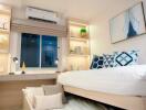 Modern bedroom with integrated storage, air conditioning, and a large bed