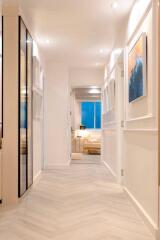 Well-lit modern hallway with artwork and access to a living area