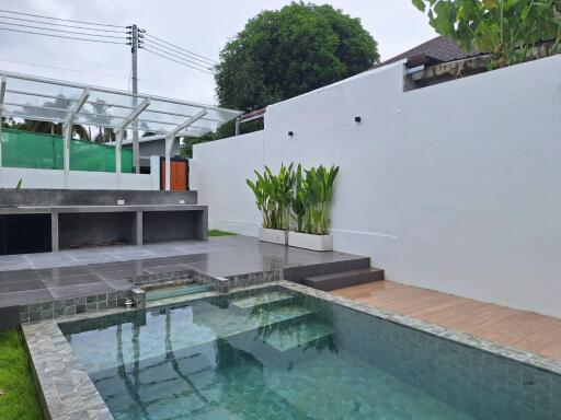 Modern backyard with swimming pool and seating area