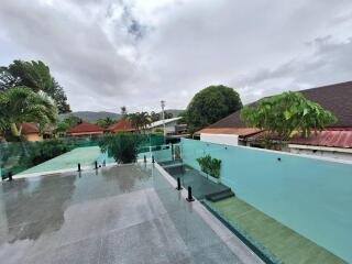 Modern outdoor pool area with glass railing