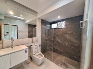 Modern bathroom with walk-in shower and toilet