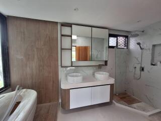 modern bathroom with double sinks and walk-in shower