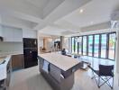 Modern open-concept kitchen and living area with island and ample natural light