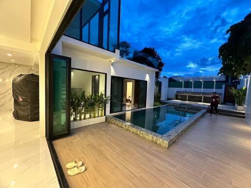 Modern outdoor space with pool and seating area