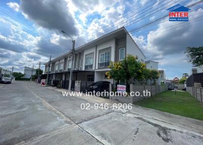 Exterior view of residential building with contact information