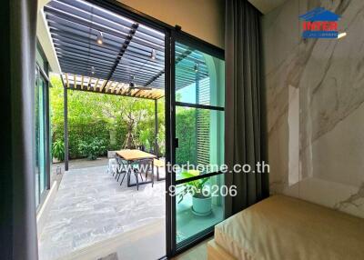 View of patio with sliding glass door and greenery