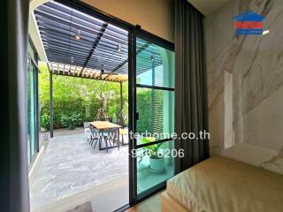 View of patio with sliding glass door and greenery