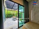 View of patio with sliding glass door and greenery