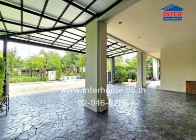 Covered outdoor area with tiled flooring and garden view