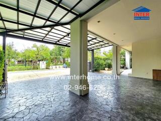 Covered outdoor area with tiled flooring and garden view