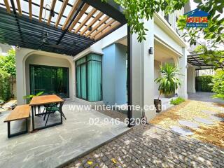 Outdoor patio with table and green garden