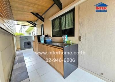 Outdoor kitchen area with countertop and cabinets