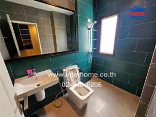 Modern bathroom with green and black tiles