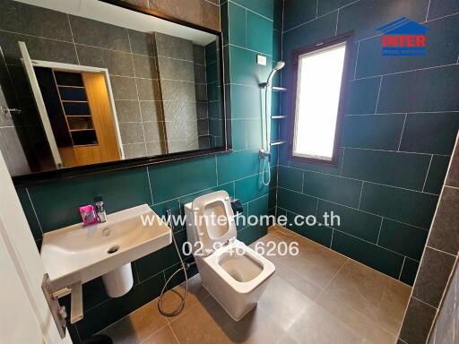 Modern bathroom with green and black tiles