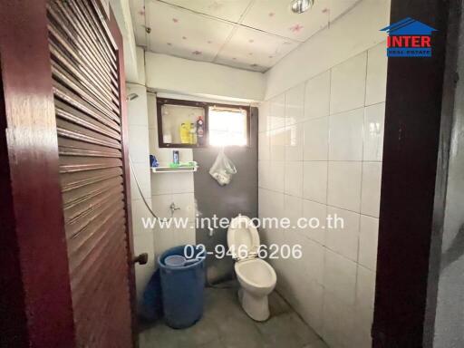 Small bathroom with a toilet and basic amenities