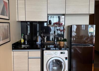 Small modern kitchen with washer and refrigerator