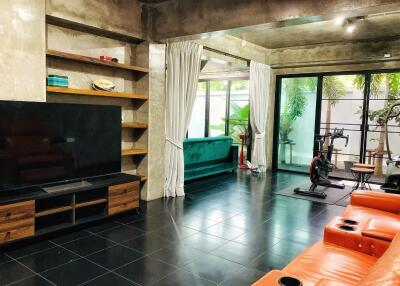 Modern living room with TV and exercise area