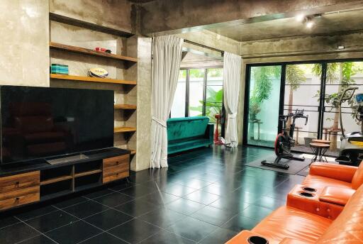 Modern living room with TV and exercise area