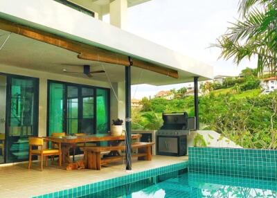 Outdoor patio area with dining table and pool