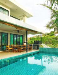 Outdoor patio area with dining table and pool