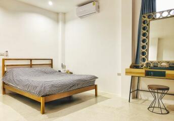 Bedroom with a wooden bed and vanity set