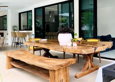 Outdoor dining space with wooden table and benches