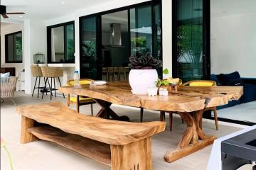 Outdoor dining space with wooden table and benches