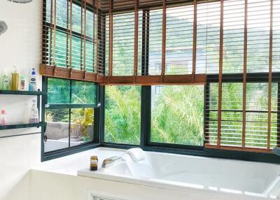 Bathroom with large tub and window blinds