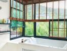 Bathroom with large tub and window blinds