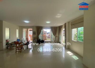 Spacious living room with natural light and modern furnishings