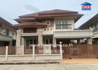 Two-story residential house with a front yard and driveway