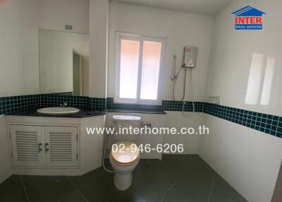 Bathroom with sink, toilet, and shower area