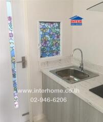 Small kitchen with a sink and stained glass windows