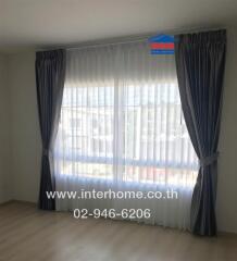 Bedroom with large window and curtains