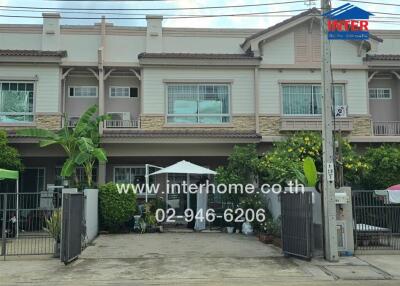 Front view of a residential building with yard space