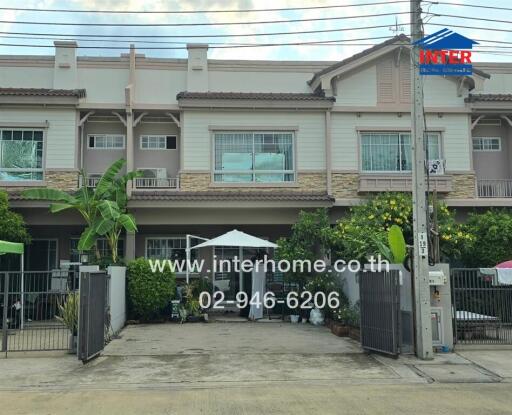 Front view of a residential building with yard space