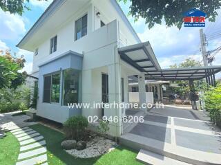 Modern two-story house with a well-maintained yard and driveway