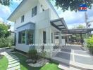 Modern two-story house with a well-maintained yard and driveway