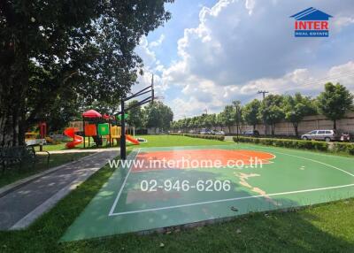 Outdoor basketball court and playground in a green park