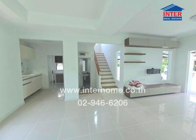 Modern living area with tiled flooring and open kitchen