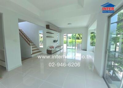 Spacious living room with modern design, large windows, and a view of the garden