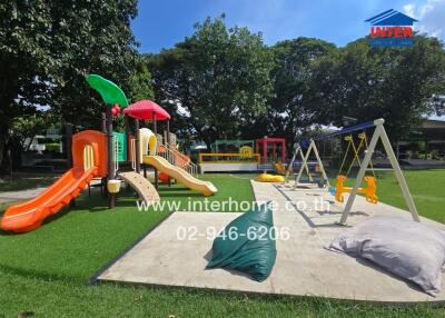 Outdoor playground with various play structures and swings