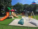 Outdoor playground with various play structures and swings