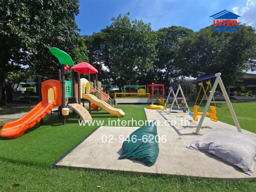 Outdoor playground with various play structures and swings