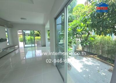 Bright living area with large windows and garden view