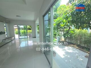 Bright living area with large windows and garden view