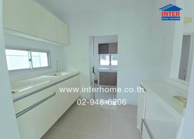 Modern white kitchen with ample storage and counter space